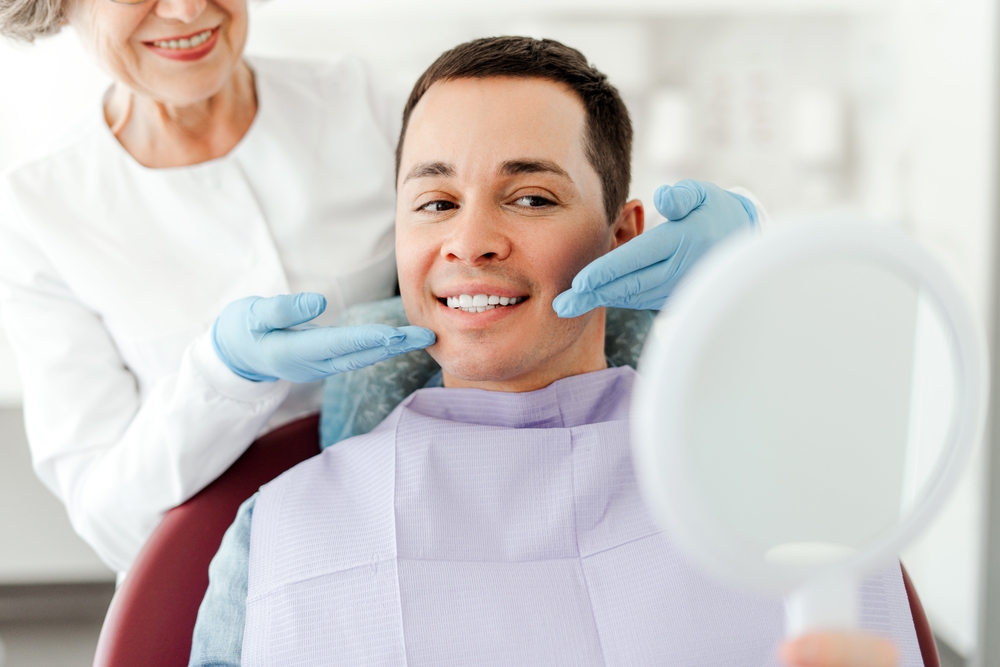 Attractive,Senior,Woman,,Dentist,Consulting,Male,Patient,,Sitting,In,Dental